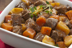 A close-up view of a bowl of Brazilian Beef Stew (Picadinho de Carne) with rice.